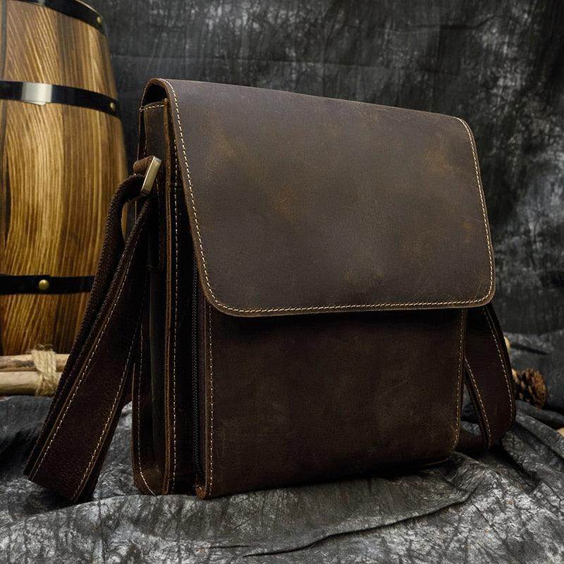 Mens leather crossbody bags in dark brown with adjustable shoulder strap and flap closure