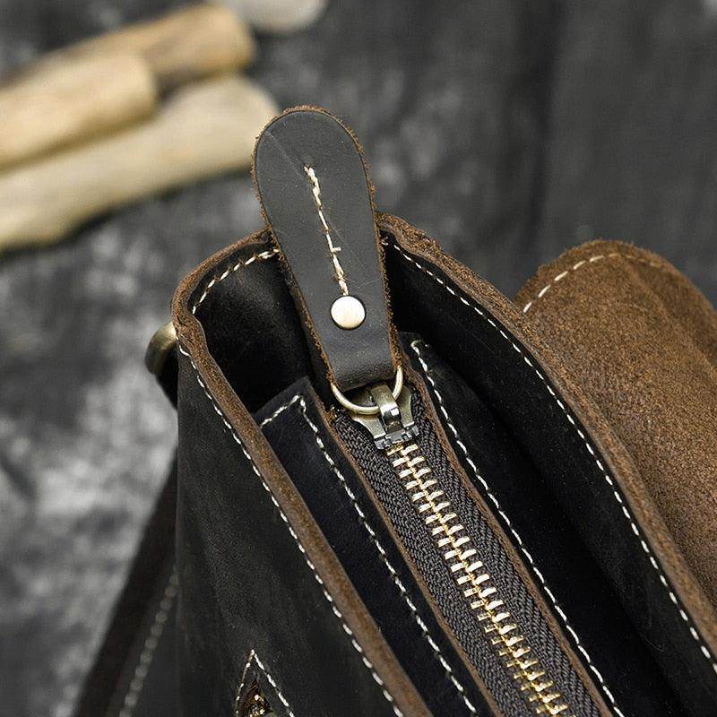 Close-up of mens leather crossbody bags showcasing zipper detail and quality craftsmanship