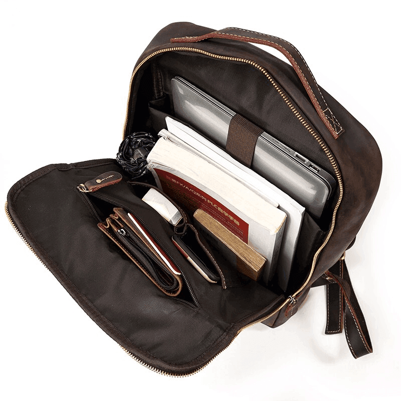Interior view of a mens leather laptop backpack with multiple compartments for organization