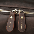 Close-up of durable zippers on the mens leather laptop backpack from VacationGrabs