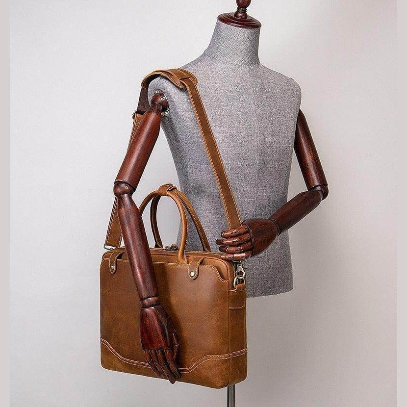 Mens leather satchel bag in tan with dual handles and adjustable shoulder strap for casual and formal use