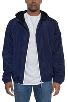 Mens navy blue windbreaker jacket with a hood and zip closure, perfect for casual wear