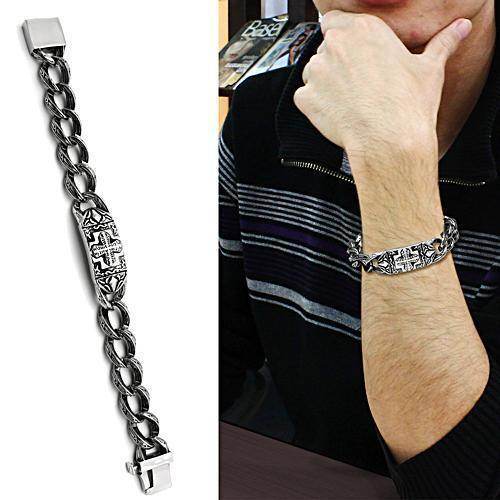 Men's polished stainless steel bracelet with a decorative center link on a model's wrist