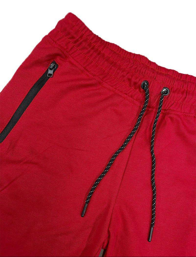 Close-up of mens red cotton shorts with elastic waistband and functional pockets by VacationGrabs
