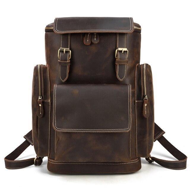 Mens retro laptop backpack in brown leather with multiple pockets and adjustable straps for travel