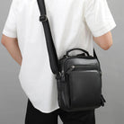 Stylish black mens retro leather shoulder bag with adjustable strap and multiple pockets