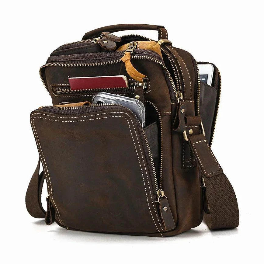 Mens retro leather shoulder bag featuring multiple pockets and an adjustable strap for travel convenience
