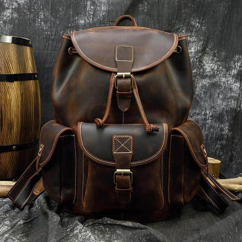 Vintage styled men's retro rucksack in brown leather with dual front pockets and adjustable straps
