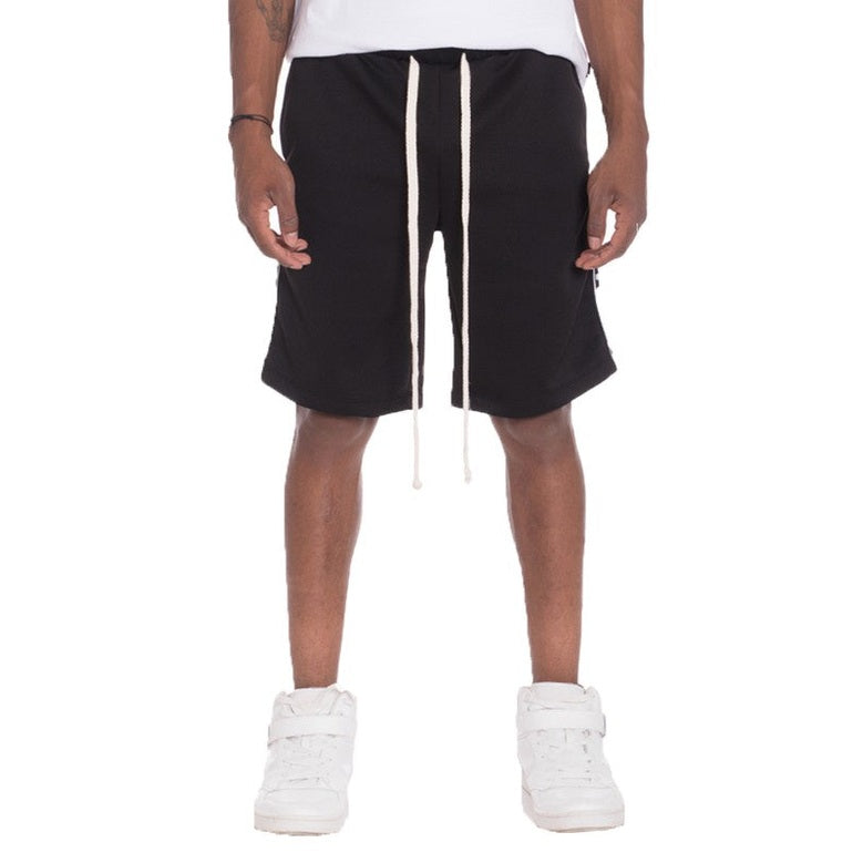 Black mens side tape checkered shorts by WEIV with white drawstrings worn with white sneakers