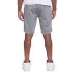 Back view of a man wearing gray mens side tape checkered shorts with white sneakers