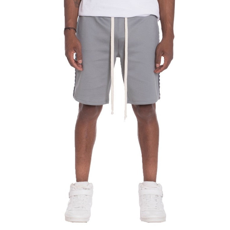 Mens side tape checkered shorts in gray with white drawstrings worn with white sneakers