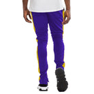 Men's slim fit track pants in purple with yellow side stripes for a sporty look