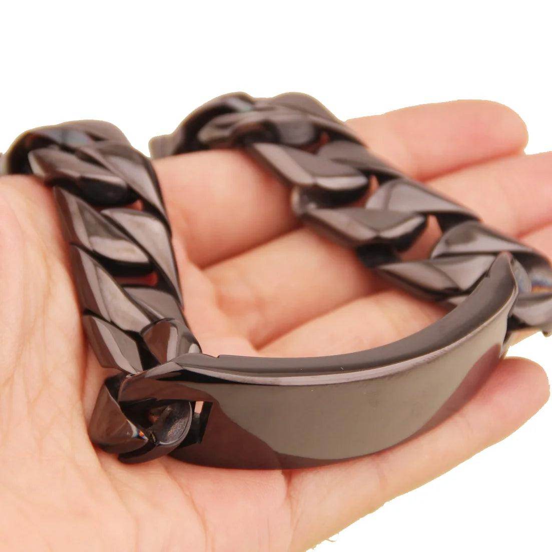 Men's stainless steel ID bracelet with a sleek design, showcasing smooth links in a hand