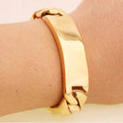 Men's stainless steel ID bracelet featuring a polished gold finish and a contemporary link design