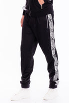 Stylish WEIV mens track suit featuring black pants with snake print side stripes for activewear