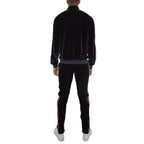 Stylish men's velour track set in black, featuring a zip-up jacket and fitted pants with contrasting stripes