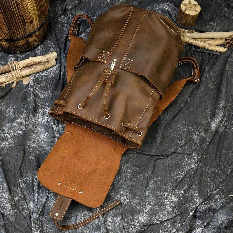 Mens vintage leather backpack with drawstring closure and suede accents for stylish travel