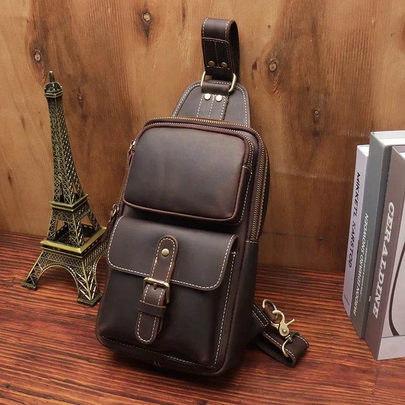 Mens vintage travel chest bag in brown leather design with multiple pockets for convenience