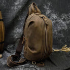 Mens vintage travel chest bag in brown leather with adjustable shoulder strap and multiple pockets