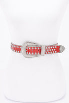 Red metal studded fashion belt with a decorative silver buckle for stylish layering