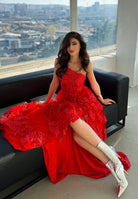Rag Company metallic high ankle boots worn by woman in red dress sitting on black couch