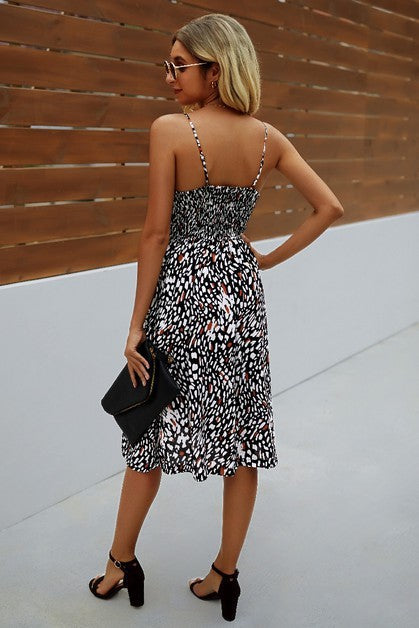 Women's black and white midi dress with adjustable straps, perfect for casual outings