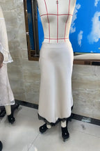 Cream midi satin skirt with lace trim for elegant occasions