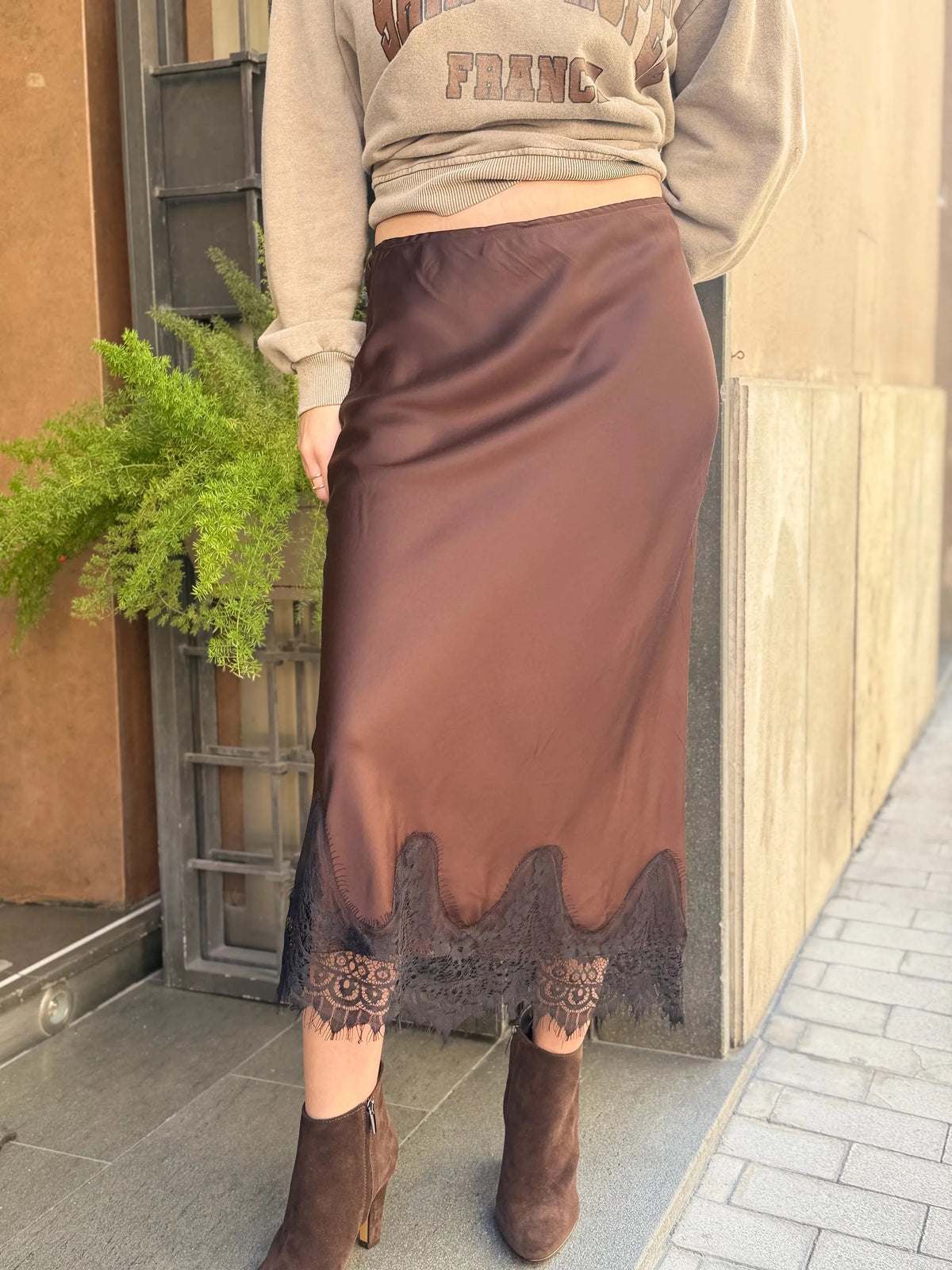 Brown satin midi skirt with lace trim, perfect for casual outings