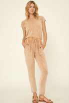 Mineral washed knit jumpsuit in soft beige with pockets and adjustable waist for women