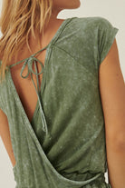 Back view of a women's mineral washed knit jumpsuit in green with tied closure and relaxed fit