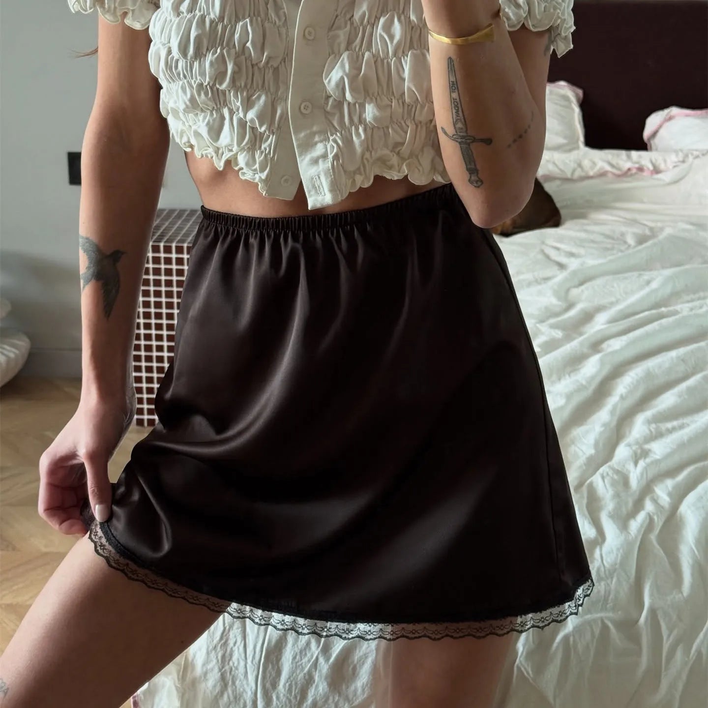 Women's black mini skirt with lace trim, perfect for casual outings