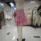 Women's red and white gingham mini skirt, perfect for summer outings.