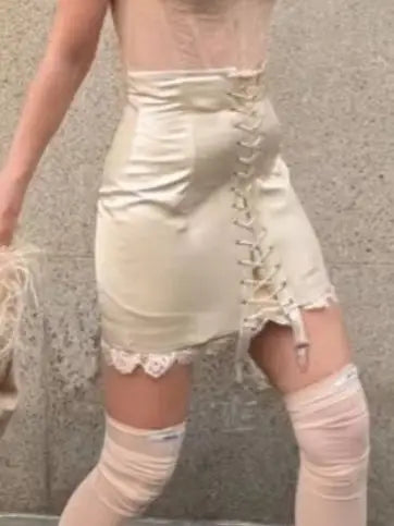 Cream mini skirt with lace-up detail, perfect for casual outings