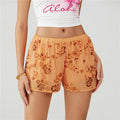 Women's orange mini skirt shorts with floral sequin detailing for summer outings