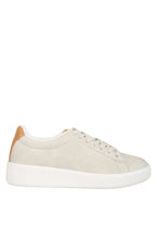 Beige sneaker with white sole on a light blue background