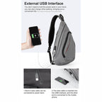 Gray USB charging crossbody backpack with external USB interface for convenient mobile device charging