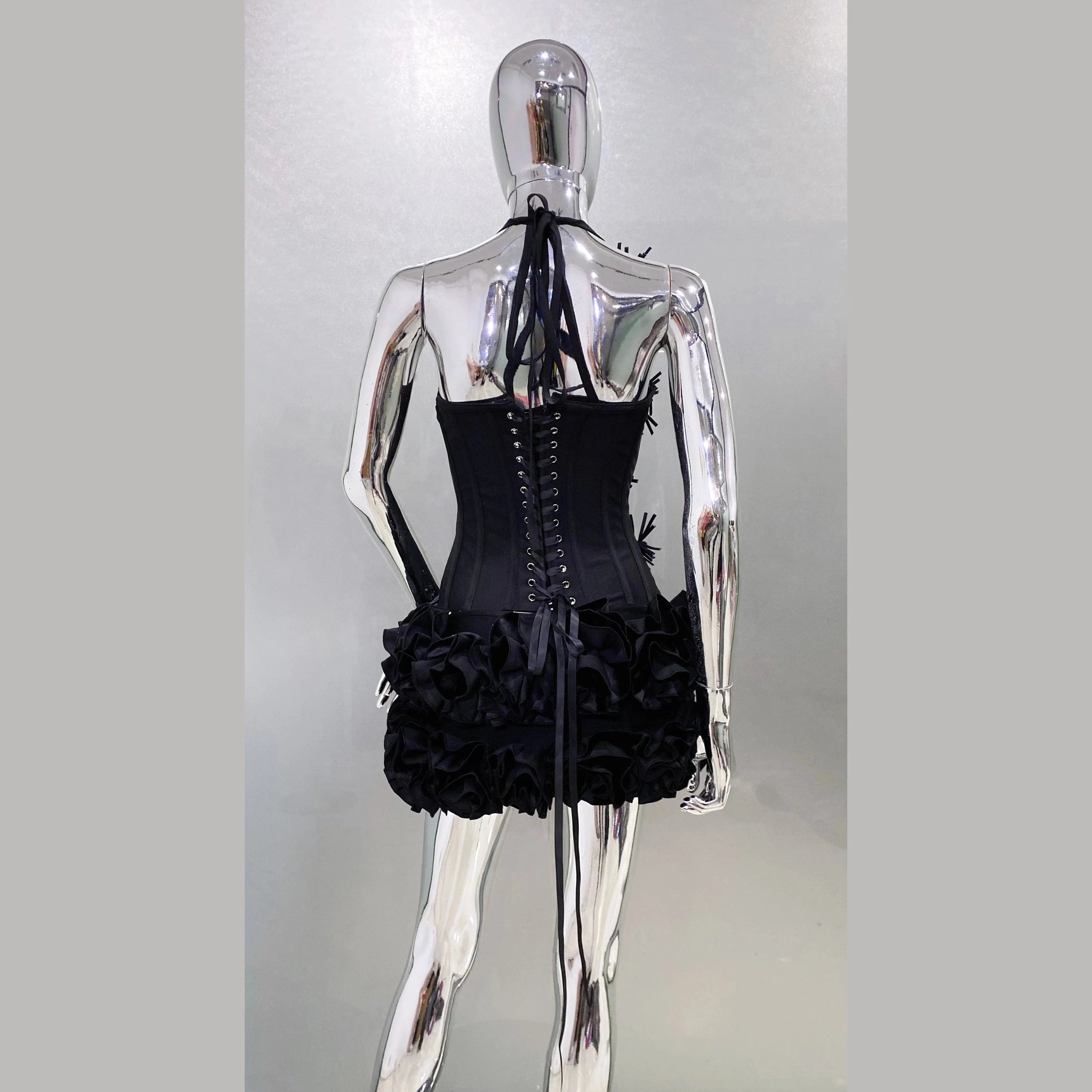 Back view of a black nightclub bandage dress for women with lace-up corset and ruffled skirt