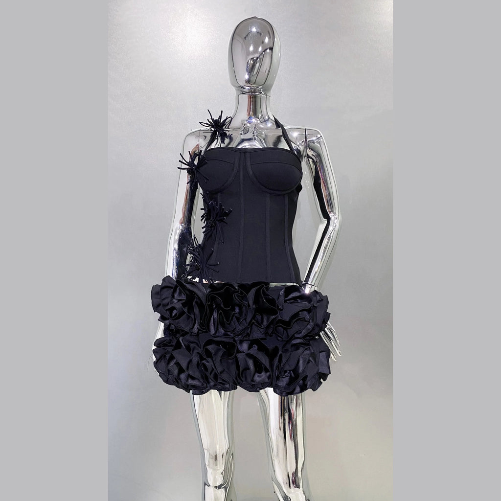 Black nightclub bandage dress for women with ruffled skirt and floral details on a silver mannequin