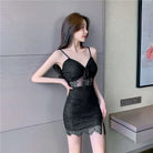 Woman wearing a black nightclub coquette slip dress with lace details and spaghetti straps