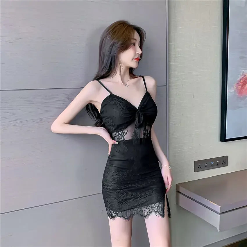 Woman wearing a black nightclub coquette slip dress with lace details and spaghetti straps