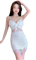 Woman wearing white lace nightclub coquette slip dress with spaghetti straps and front slit
