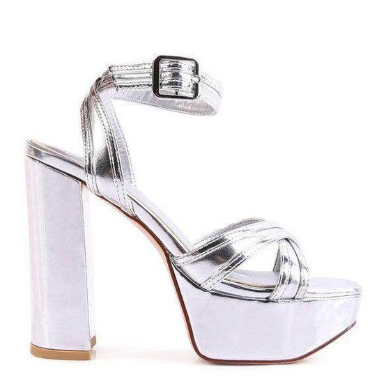 Silver Nyle heeled sandals with a thick platform and adjustable ankle strap for stylish elevation
