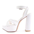 White Nyle heeled sandals with a chunky platform and ankle strap design for stylish elevation