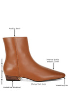 Obita leather boots for vacation featuring a closed snip toe and stacked low block heel