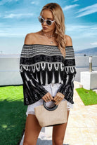 Stylish off shoulder graphic print top for women, paired with white shorts and a handbag