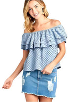 Ivory Felix off shoulder polka dot top in blue with ruffle design and paired with a distressed denim skirt