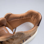 Inside view of tan sneakers with a platform, featuring cushioned insole