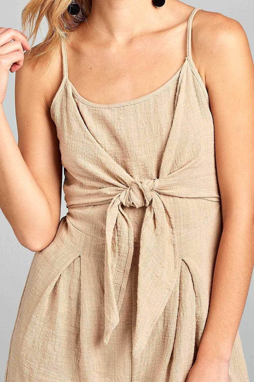 Ivory Felix one-piece romper with open back featuring a stylish tie front design and soft fabric