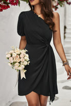 Elegant one shoulder puff sleeve dress in black featuring a tie waist and flattering silhouette