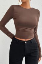 Women's open back long sleeve top in brown with a fitted design and stylish ruched waist